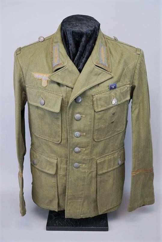 A green military uniform

Description automatically generated with low confidence