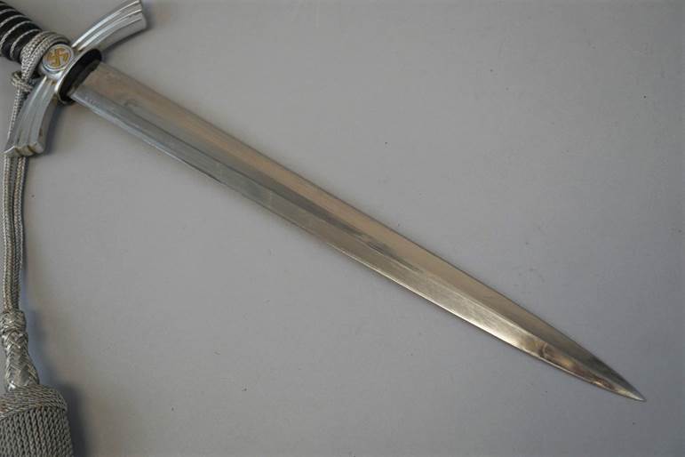 A sword on a white surface

Description automatically generated with low confidence