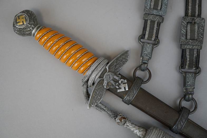 A picture containing wall, indoor, weapon, sword

Description automatically generated