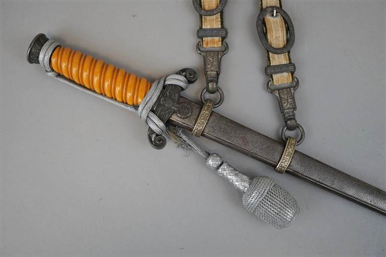 A picture containing weapon, indoor, sword, knife

Description automatically generated