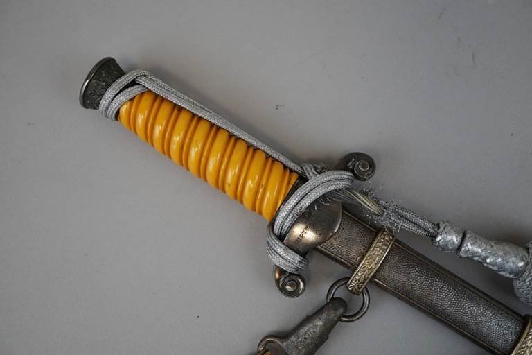 A close-up of a sword

Description automatically generated with low confidence