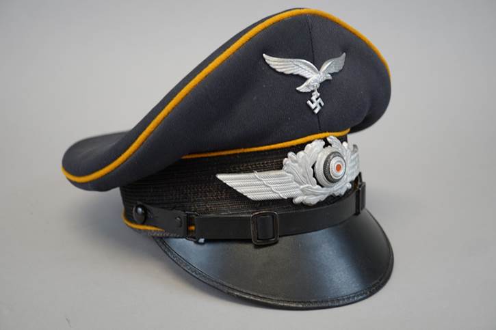 A picture containing headdress, black, hat, helmet

Description automatically generated