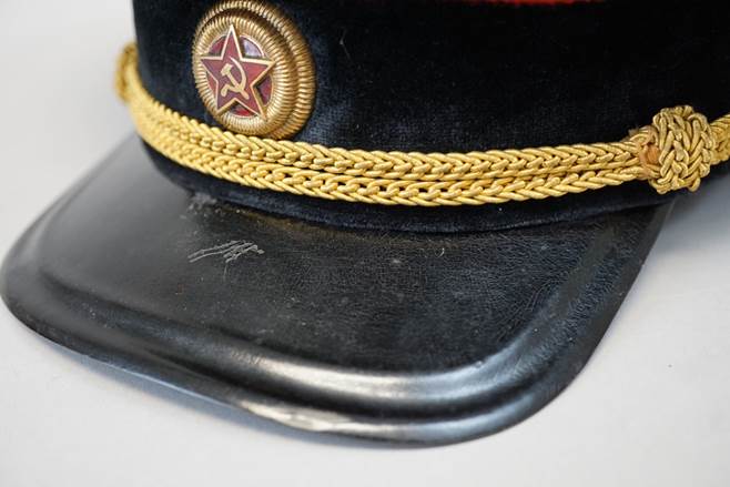 A black hat with a gold band

Description automatically generated with low confidence