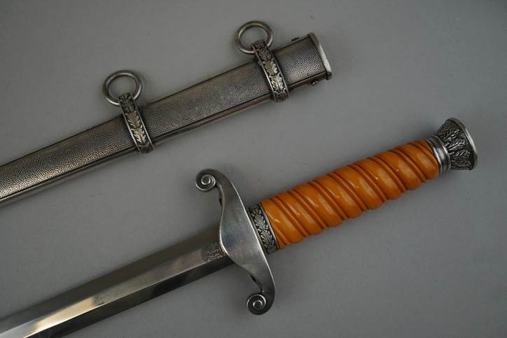 A picture containing weapon, indoor, wall, sword

Description automatically generated