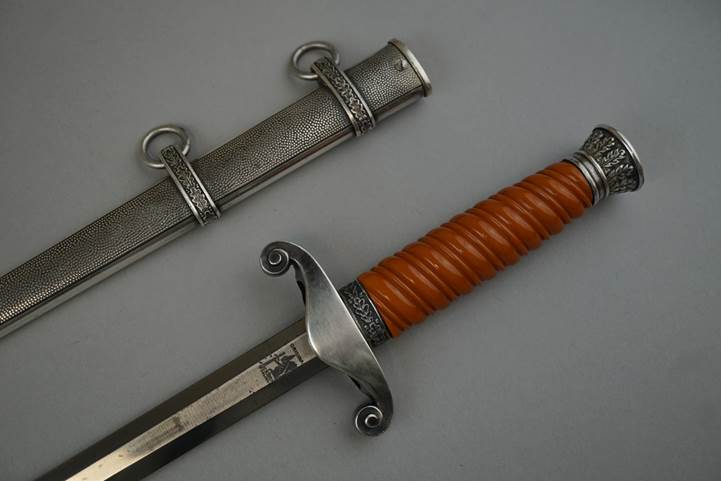 A picture containing weapon, knife, indoor, sword

Description automatically generated