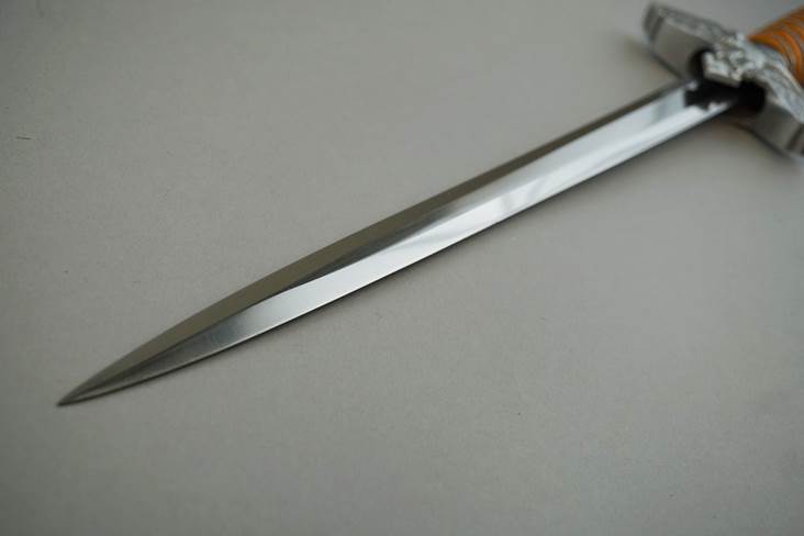 A sword on a white surface

Description automatically generated with medium confidence
