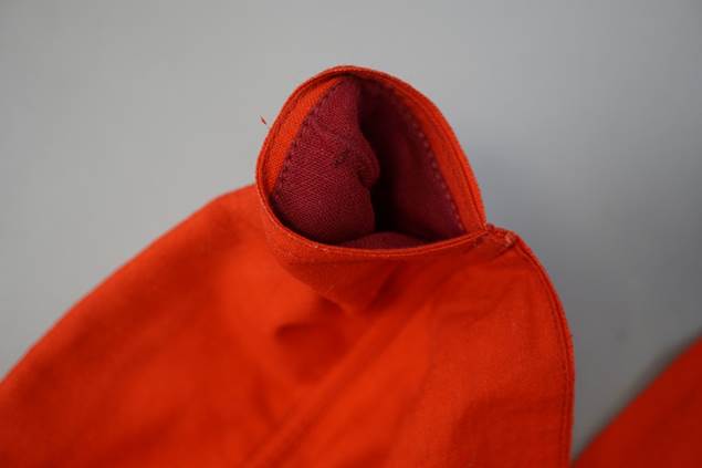 A picture containing orange, clothing, person, red

Description automatically generated