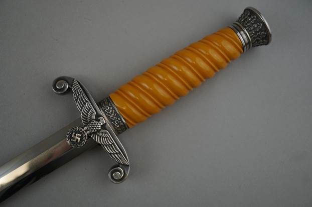 A close up of a sword

Description automatically generated with low confidence