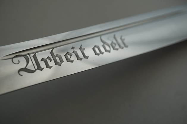 Close-up of a metal object with writing on it

Description automatically generated with low confidence