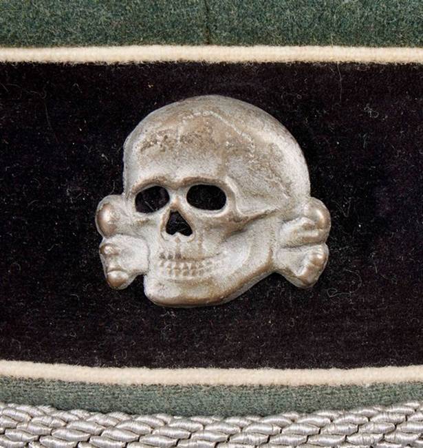 A skull and crossbones on a black and green hat

Description automatically generated with low confidence