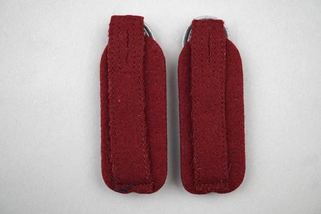 A pair of red fabric straps

Description automatically generated