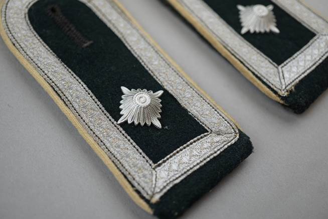 Close-up of a pair of military uniforms

Description automatically generated