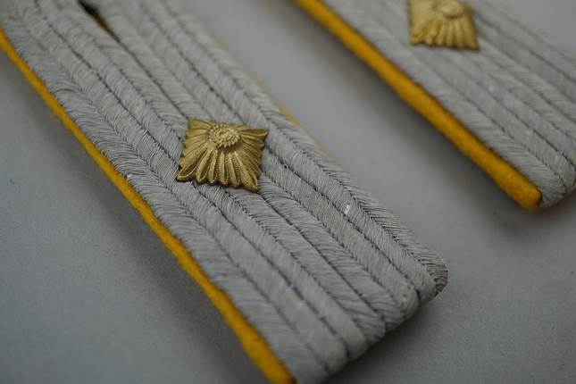 Close-up of a pair of military uniforms

Description automatically generated