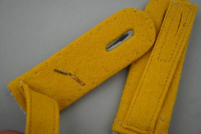 Close-up of a yellow felt strap

Description automatically generated