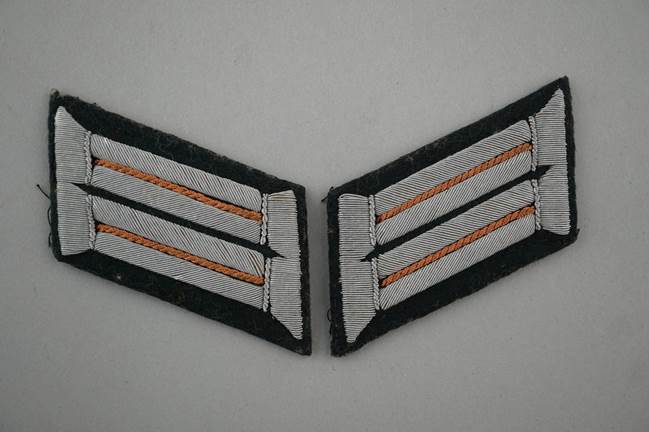 Close-up of a striped uniform insignia

Description automatically generated