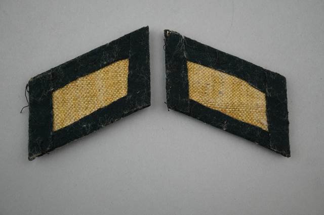 A pair of black and yellow patches

Description automatically generated