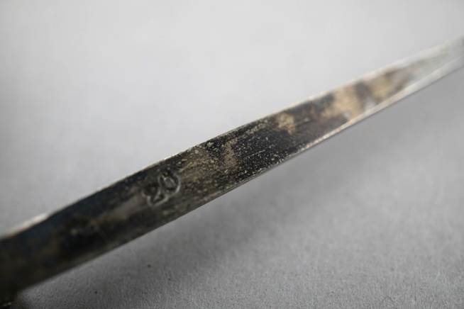 Close-up of a metal blade

Description automatically generated