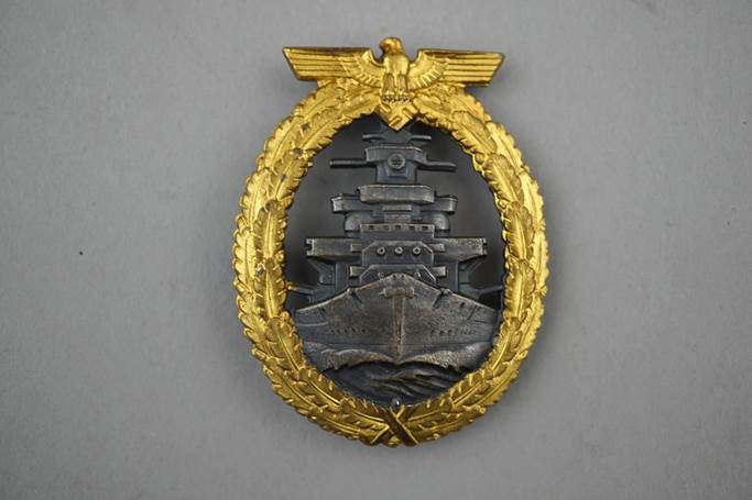 A gold and silver military badge

Description automatically generated