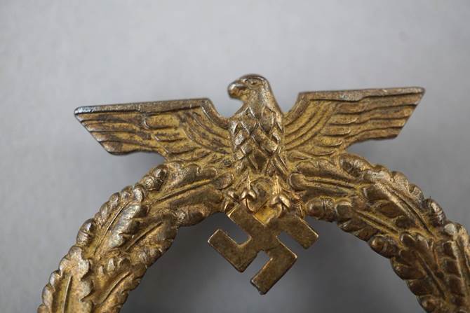 A close-up of a gold eagle

Description automatically generated