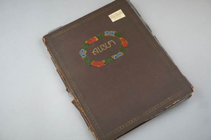 A brown album with a flower design

Description automatically generated