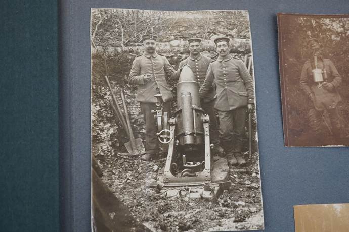 A group of men standing next to a cannon

Description automatically generated