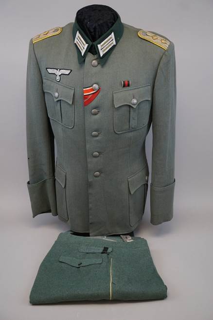 A military uniform with a white shirt and a red and white logo

Description automatically generated with medium confidence