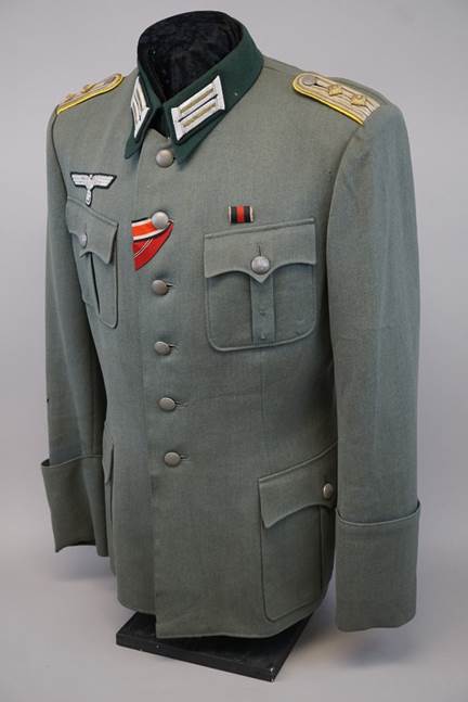 A military uniform with a red and white flag

Description automatically generated with medium confidence
