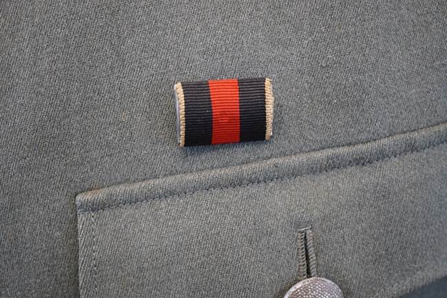 A close-up of a badge on a jacket

Description automatically generated