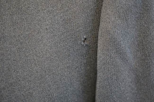 A close-up of a grey sweater

Description automatically generated