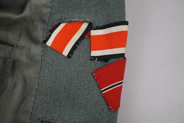 A close-up of a patch of red and white stripes

Description automatically generated