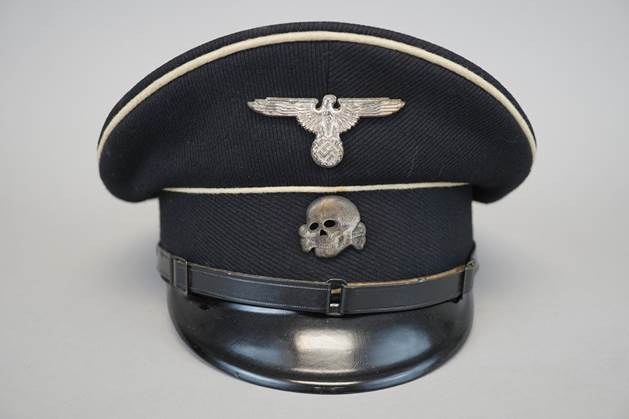 A black hat with a skull and a badge

Description automatically generated