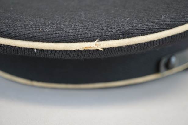 A close-up of a black hat

Description automatically generated