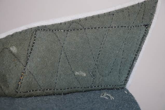 Close-up of a cushion with stitching

Description automatically generated
