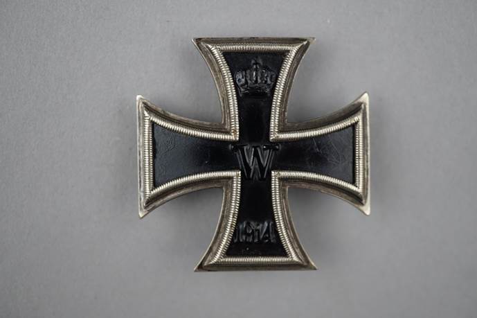 A black and silver cross

Description automatically generated