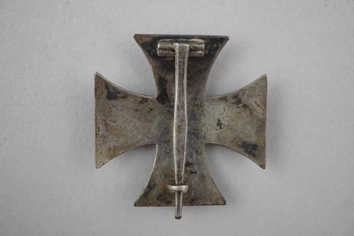 A close-up of a metal cross

Description automatically generated