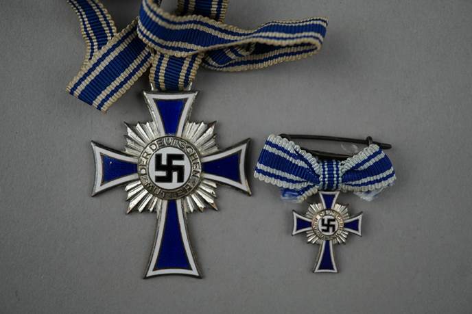 A group of medals with blue ribbons

Description automatically generated