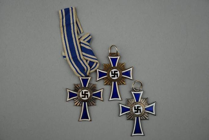 Several medals with a blue and white ribbon

Description automatically generated with medium confidence
