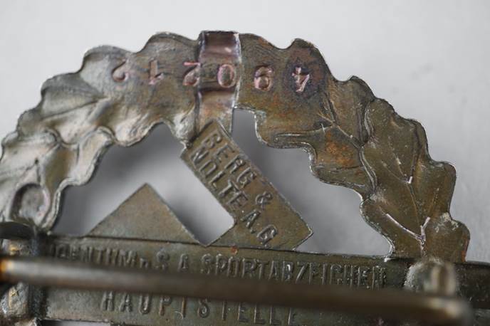 Close-up of a metal badge

Description automatically generated