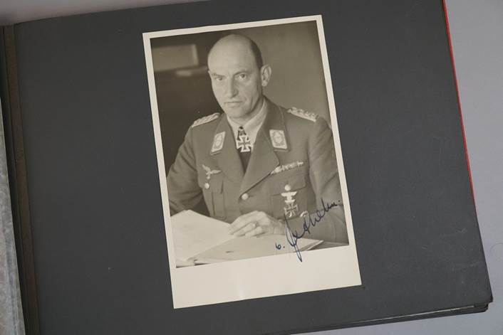 A black and white photo of a person in a military uniform

Description automatically generated