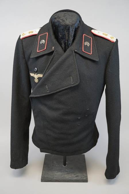 A black jacket with red and white patches

Description automatically generated