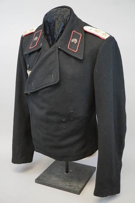 A black jacket with red patches

Description automatically generated
