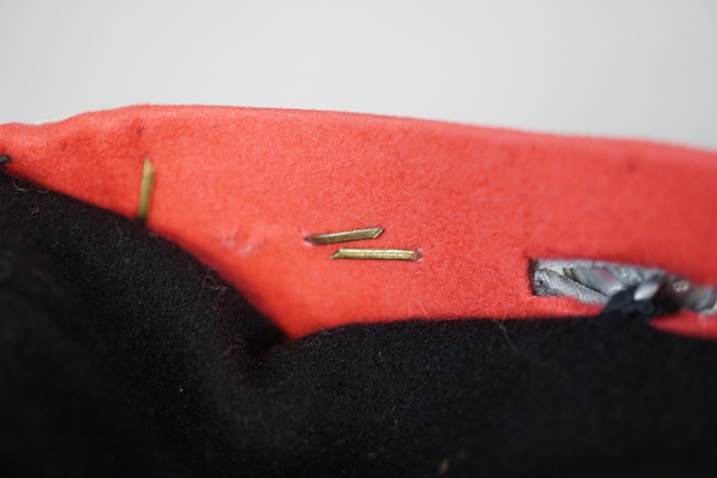 A close-up of a red and black felt

Description automatically generated