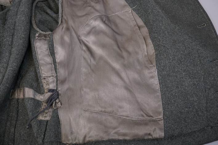 A close-up of a grey vest

Description automatically generated