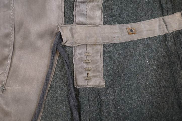 Close-up of a grey fabric with a strap

Description automatically generated