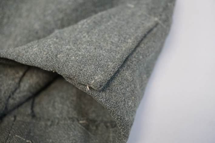 Close-up of a grey fabric

Description automatically generated