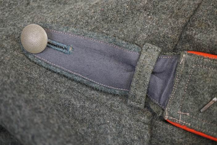 A close-up of a button on a jacket

Description automatically generated