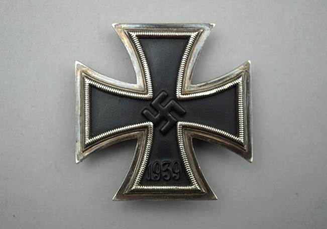 A black and silver cross

Description automatically generated