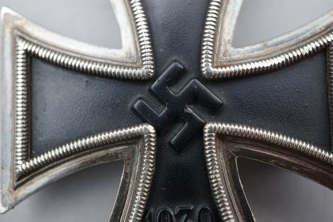 Close-up of a black and silver cross

Description automatically generated
