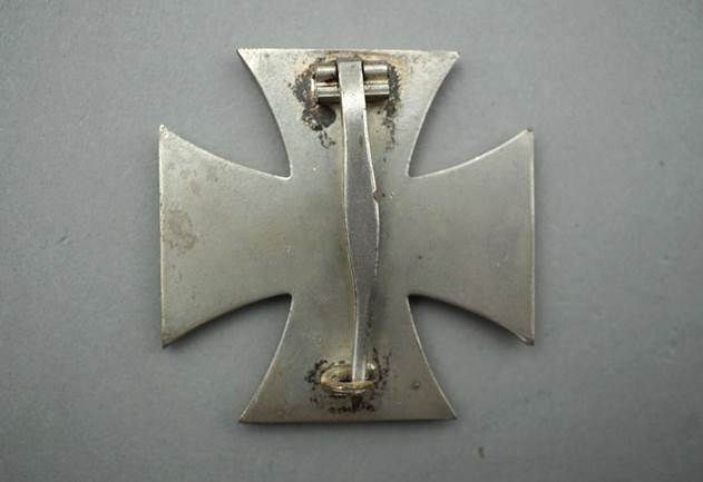 A close-up of a metal cross

Description automatically generated