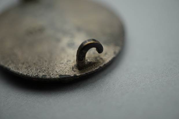 A close-up of a metal hook

Description automatically generated